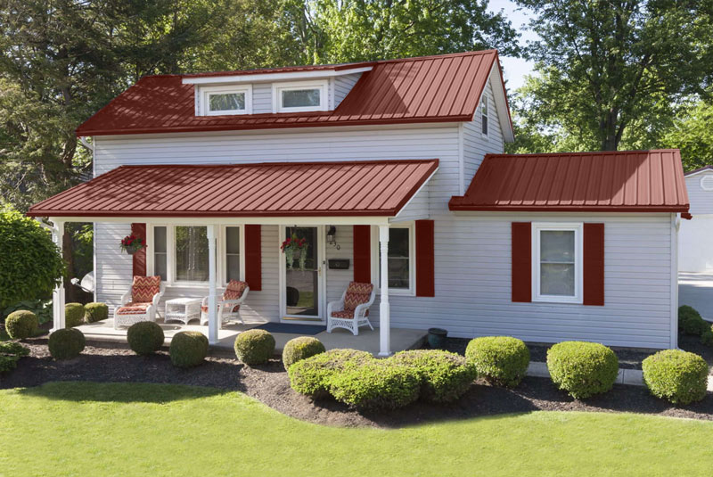 An image of a house with a dark red metal roof