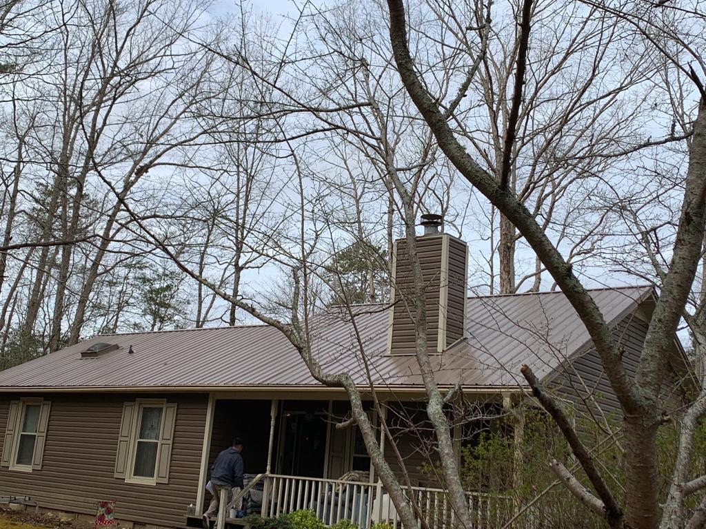 An image of a house with a Sierra Tan roof by Metal Roofing Colors