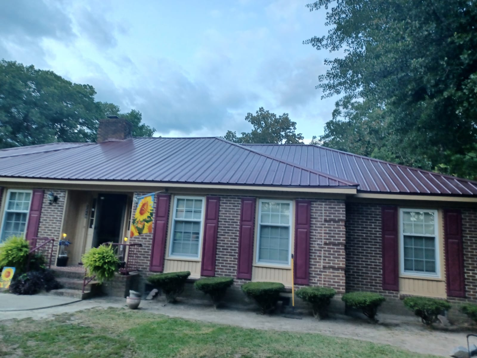 An image of a house with a roof by Metal Roofing Colors